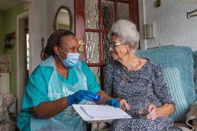 Care at Home worker giving medication to service user