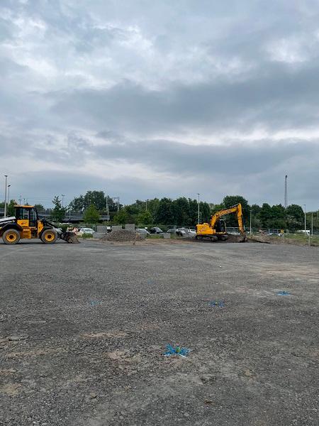 View looking east across the gravel plateau that forms the outline of the building and the piling mat. 